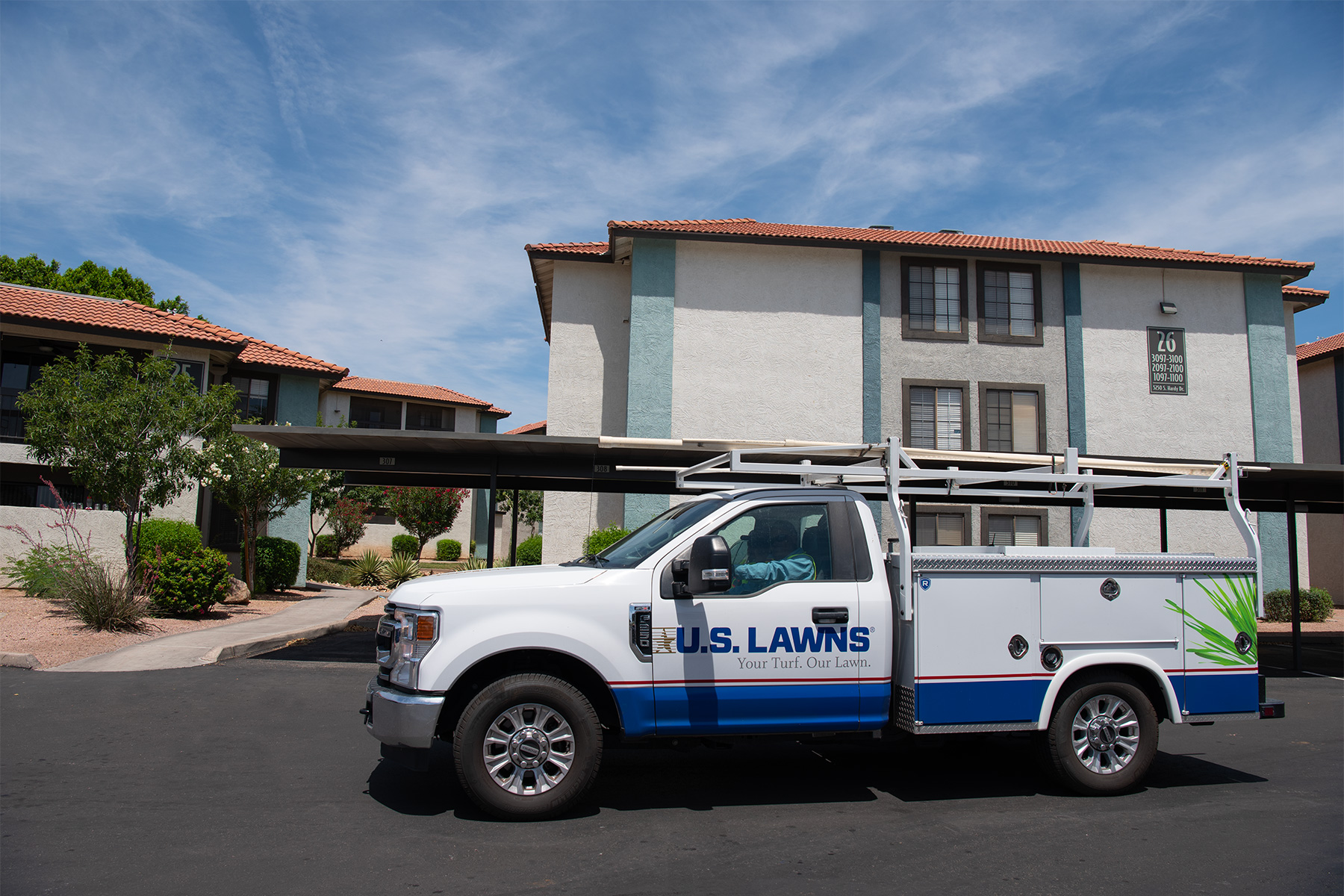 Commercial landscaping service truck on-site at a multi-family property in the Phoenix metro area